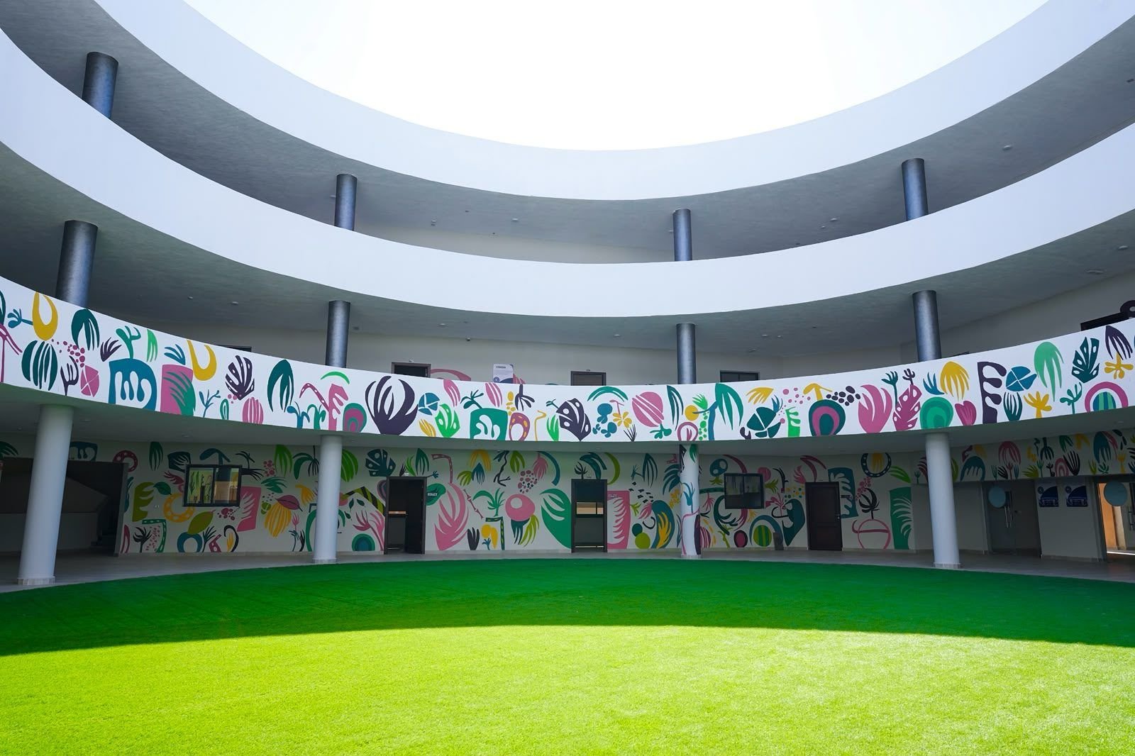 Open-air atrium with colorful murals